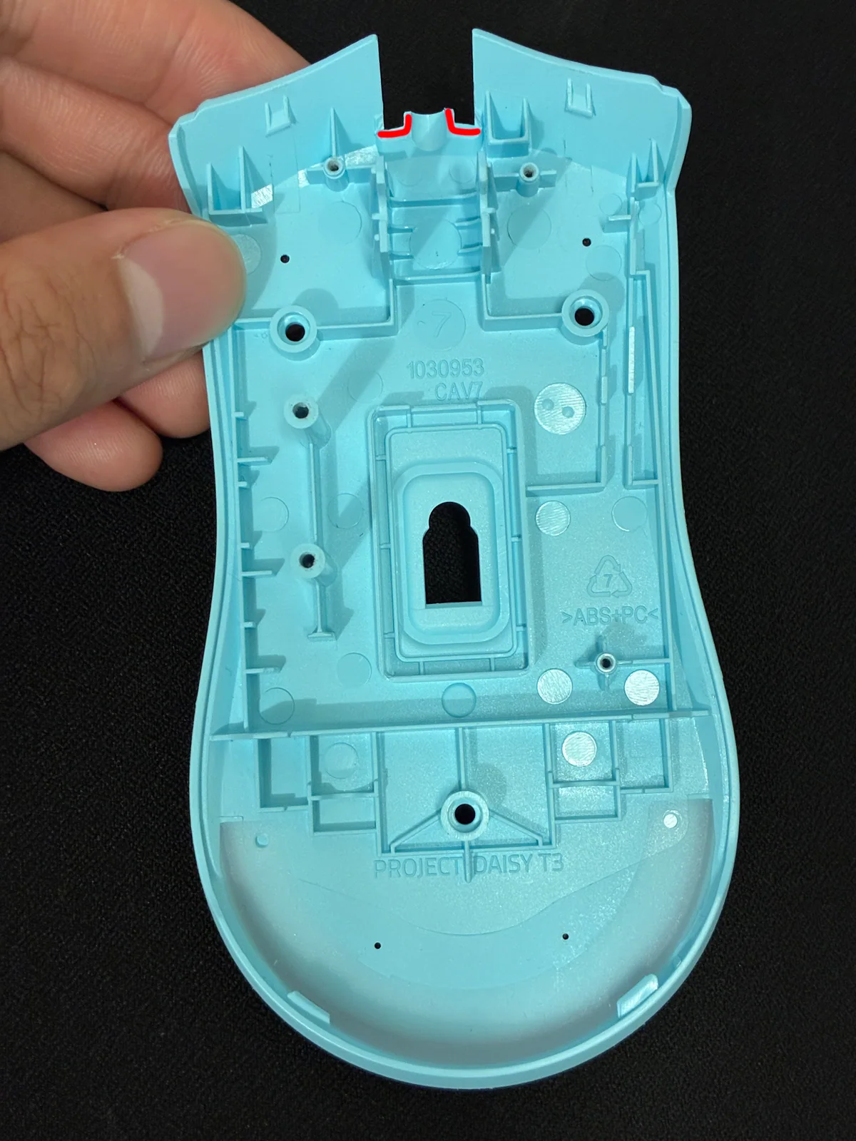 Red line marks plastic to remove from the bottom shell