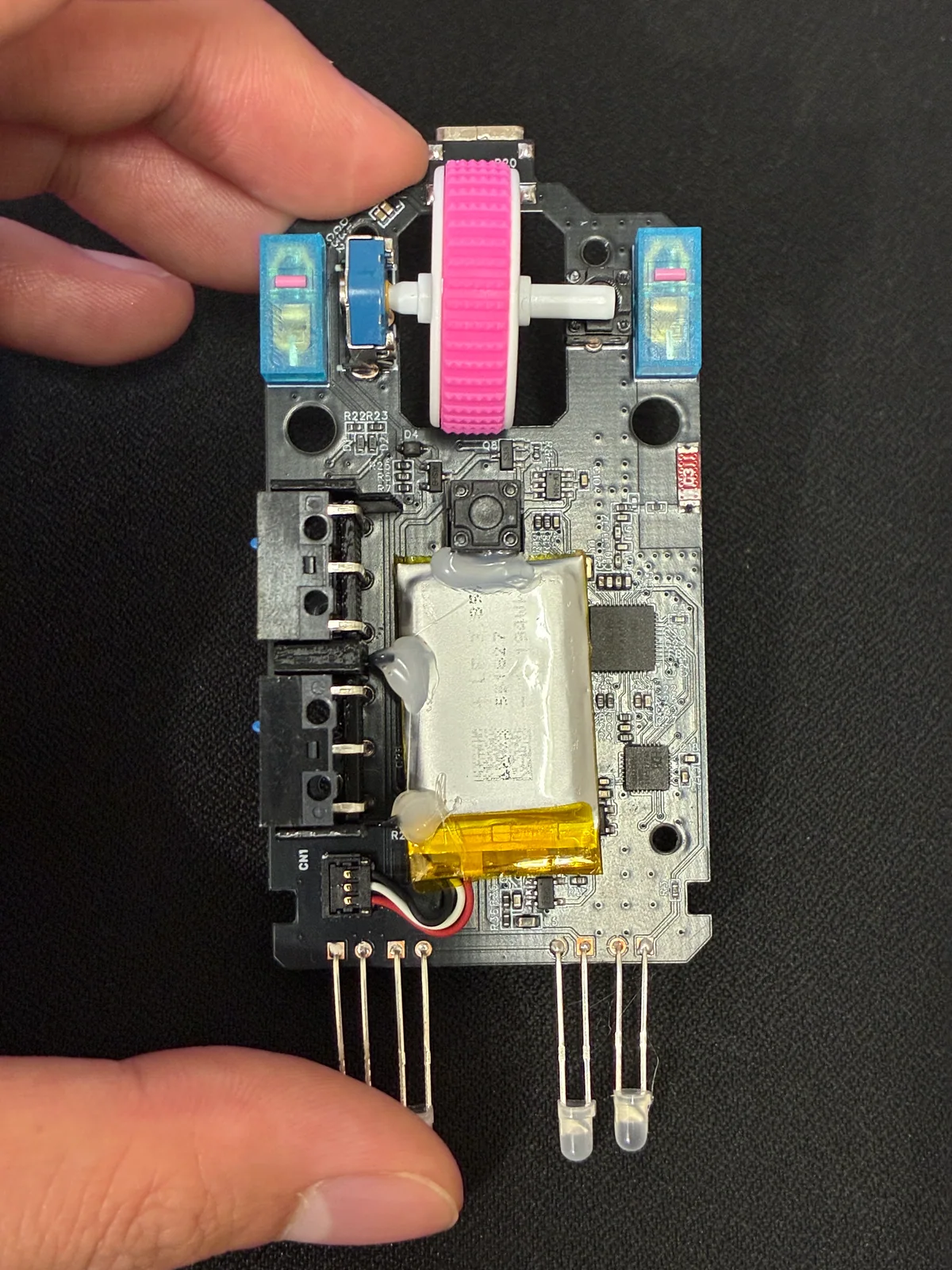 Hold the new PCB with the scroll wheel installed